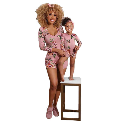 Mother and child in matching pink floral long-sleeve rompers with shorts, perfect for summer.