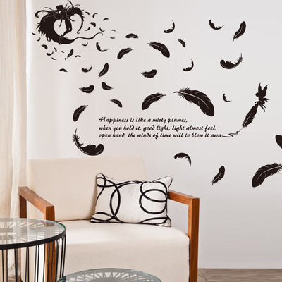 Black feather and fairy wall sticker with an inspirational quote on a teal wall above a patterned sofa. - Image 6