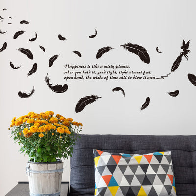 Black feather and fairy wall sticker with an inspirational quote on a teal wall above a patterned sofa. - Image 10