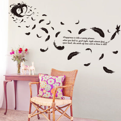 Black feather and fairy wall sticker with an inspirational quote on a teal wall above a patterned sofa. - Image 8