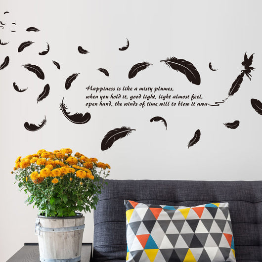 Black feather and fairy wall sticker with an inspirational quote on a teal wall above a patterned sofa. - Image 3
