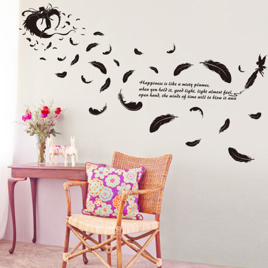 Black feather and fairy wall sticker with an inspirational quote on a teal wall above a patterned sofa. - Image 2