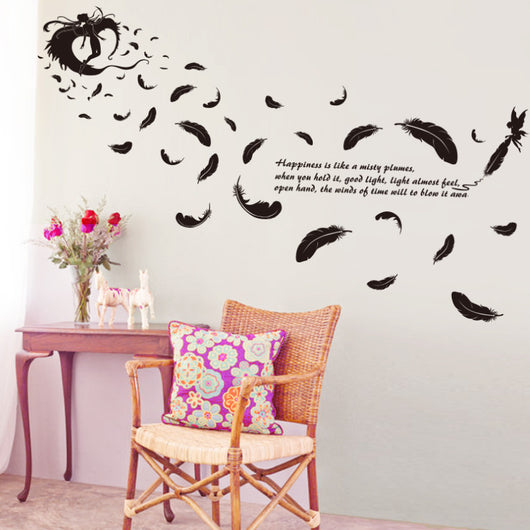 Black feather and fairy wall sticker with an inspirational quote on a teal wall above a patterned sofa. - Image 2
