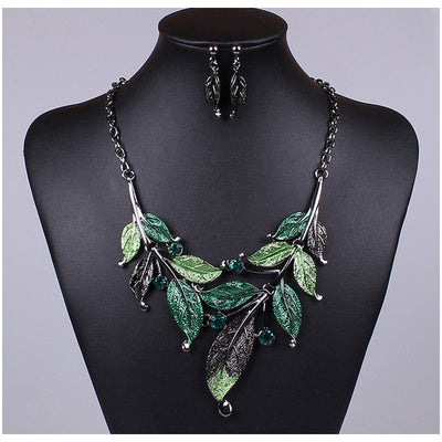 Blue enamel leaf necklace and matching earrings set with silver-tone vines and sparkling rhinestones, displayed on a black mannequin. - Image 3