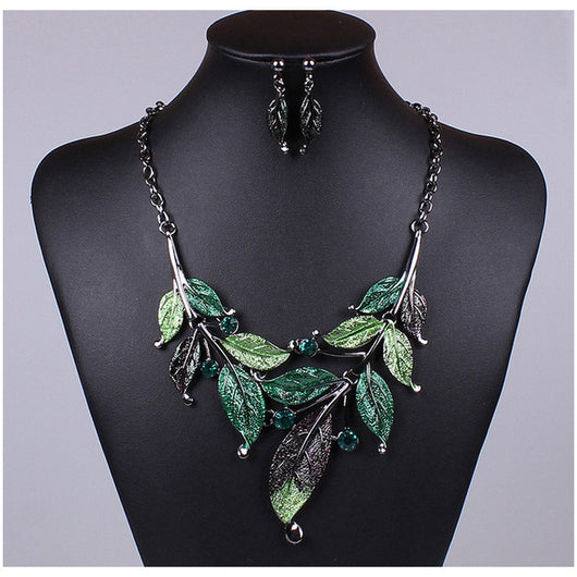 Blue enamel leaf necklace and matching earrings set with silver-tone vines and sparkling rhinestones, displayed on a black mannequin. - Image 3