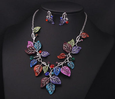 Blue enamel leaf necklace and matching earrings set with silver-tone vines and sparkling rhinestones, displayed on a black mannequin. - Image 4