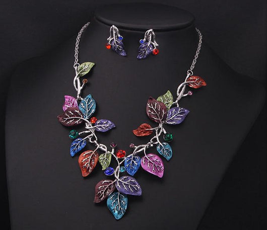 Blue enamel leaf necklace and matching earrings set with silver-tone vines and sparkling rhinestones, displayed on a black mannequin. - Image 4