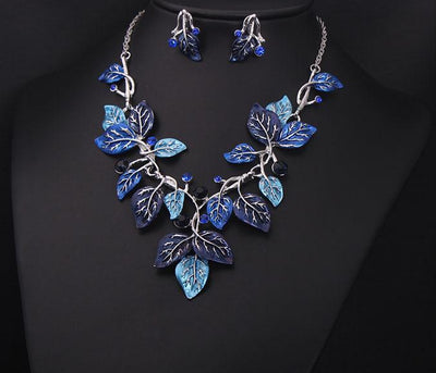 Blue enamel leaf necklace and matching earrings set with silver-tone vines and sparkling rhinestones, displayed on a black mannequin. - Image 5