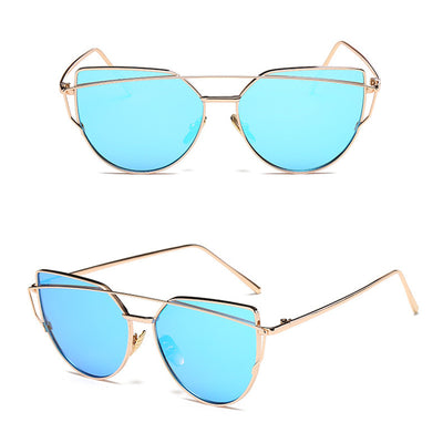 Ultralight women's cat-eye sunglasses with a gold metal frame, dark gray lenses, and a distinctive double bridge. - Image 3