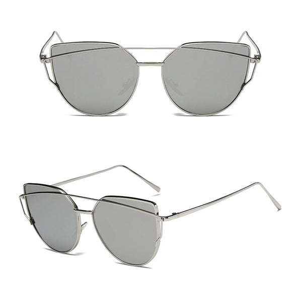 Ultralight women's cat-eye sunglasses with a gold metal frame, dark gray lenses, and a distinctive double bridge.