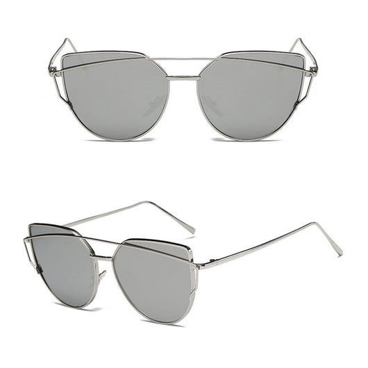 Ultralight women's cat-eye sunglasses with a gold metal frame, dark gray lenses, and a distinctive double bridge.