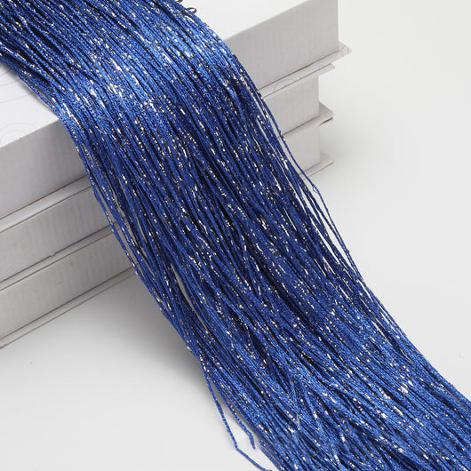 Champagne string curtain with flashing silver metallic threads, draped over white boxes. - Image 25