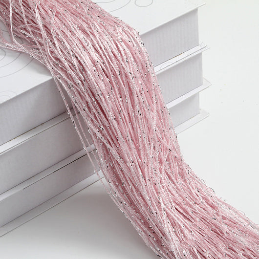 Champagne string curtain with flashing silver metallic threads, draped over white boxes. - Image 27
