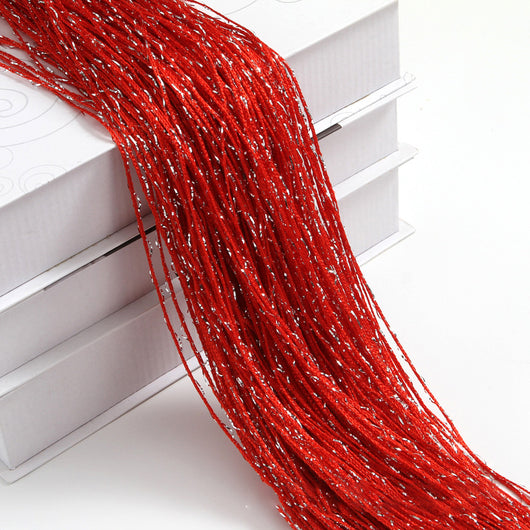 Champagne string curtain with flashing silver metallic threads, draped over white boxes. - Image 30
