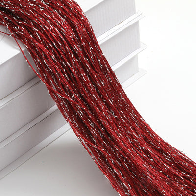 Champagne string curtain with flashing silver metallic threads, draped over white boxes. - Image 31