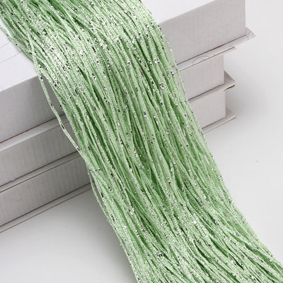 Champagne string curtain with flashing silver metallic threads, draped over white boxes. - Image 18