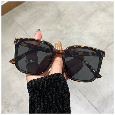 Two pairs of square-frame sunglasses, one with a cream frame and dark lenses, the other with a translucent brown frame and brown lenses. - Image 9