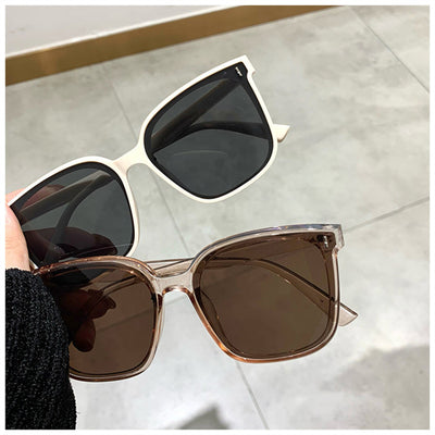 Two pairs of square-frame sunglasses, one with a cream frame and dark lenses, the other with a translucent brown frame and brown lenses. - Image 4