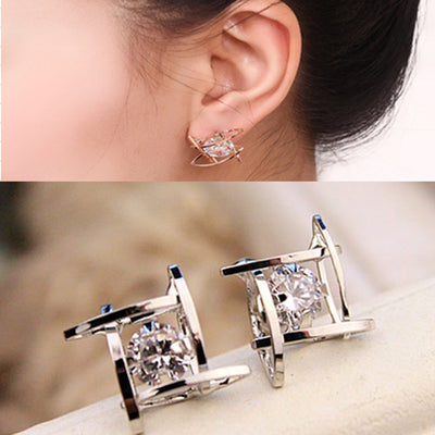 Gold-tone square stud earrings with clear zircon gemstones set in a hollow tic-tac-toe geometric frame. - Image 9