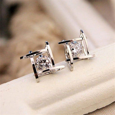 Gold-tone square stud earrings with clear zircon gemstones set in a hollow tic-tac-toe geometric frame. - Image 12