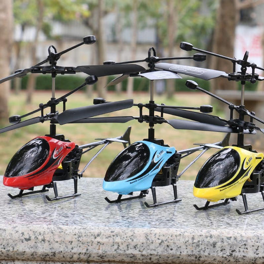 Yellow and black remote control helicopter toy with dual rotors and landing gear, resting on a light outdoor surface. - Image 4