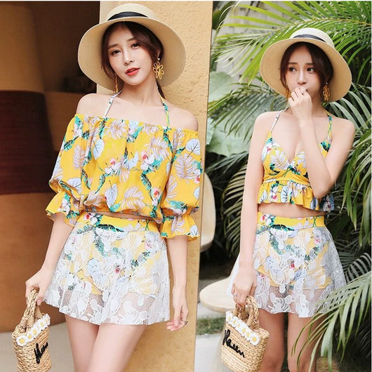 Two women in a three-piece floral swimsuit set with white lace skirts and wide-brim straw hats, posing outdoors. - Image 4