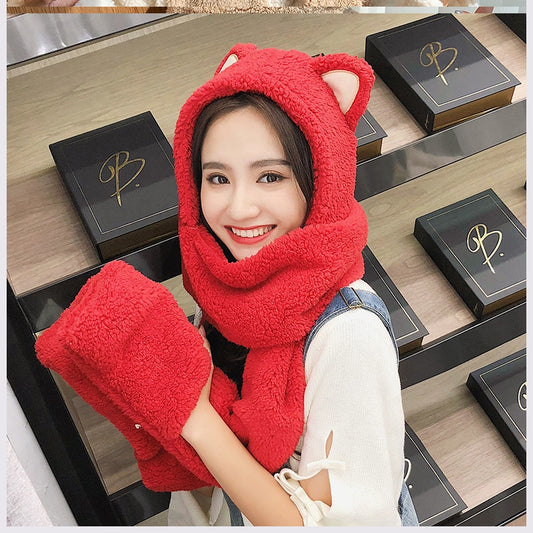 Young woman wearing a beige plush hat, scarf, and glove set with cute bear ears on the hood.
