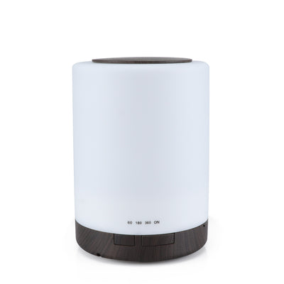 Cylindrical ultrasonic aroma diffuser with a white body and dark wood grain base and top, featuring timer settings.