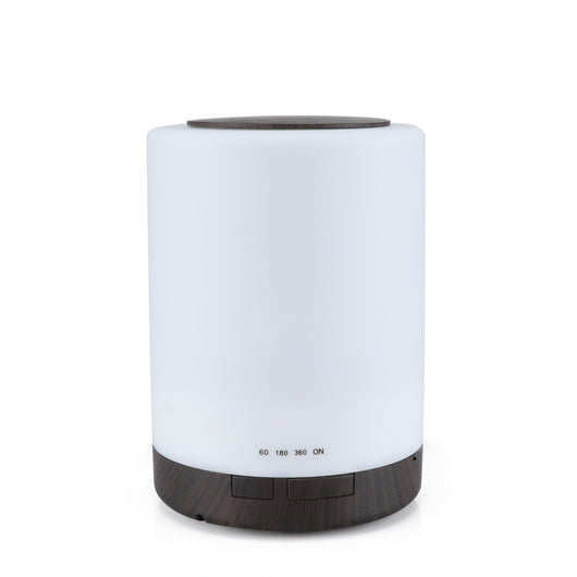 Cylindrical ultrasonic aroma diffuser with a white body and dark wood grain base and top, featuring timer settings.