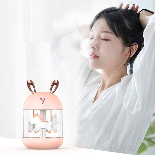 White dream pony humidifier with rose gold deer antlers and a clear tank showing a white carousel pony. - Image 12