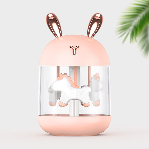 White dream pony humidifier with rose gold deer antlers and a clear tank showing a white carousel pony.