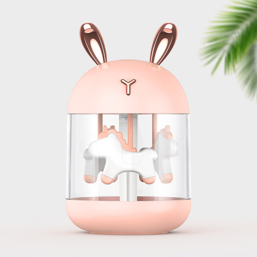 White dream pony humidifier with rose gold deer antlers and a clear tank showing a white carousel pony.