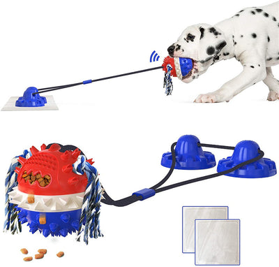 Yellow Labrador Retriever playing with a red and blue suction cup dog toy that dispenses food.