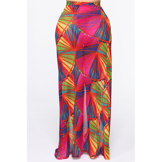 Woman wearing a vibrant multi-color abstract print three-piece bikini set with a matching sheer sarong on a balcony. - Image 8