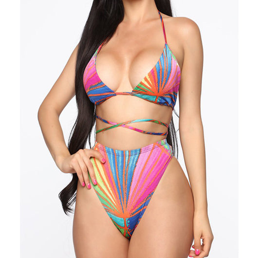 Woman wearing a vibrant multi-color abstract print three-piece bikini set with a matching sheer sarong on a balcony. - Image 14