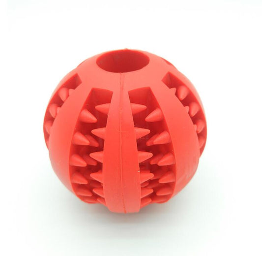 Red rubber slow feeder dog toy, a spherical ball with internal spikes and an opening for dispensing treats.