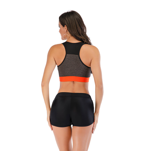 Black and orange sports vest bikini set with boxer shorts and mesh side panels modeled by a woman. - Image 11