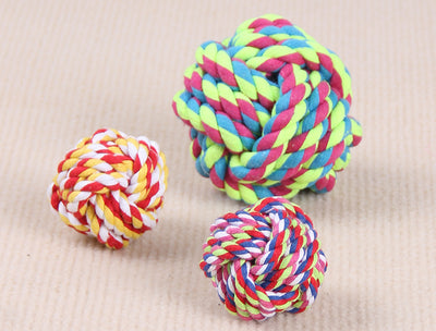 Three colorful knotted cotton rope ball dog toys in various sizes on a light beige surface. - Image 3