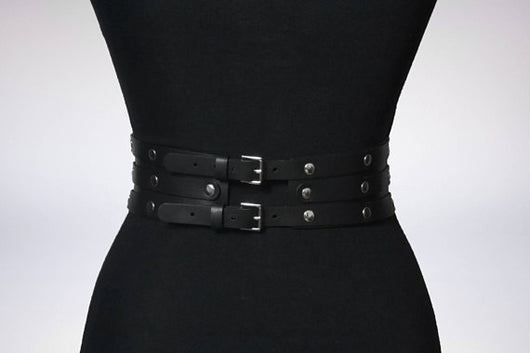Women's black leather waist belt with three layers, silver-tone metal O-rings, and rivets on a black mannequin. - Image 8