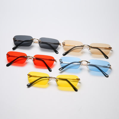Rimless rectangular sunglasses with light blue lenses, gold-colored metal temples, and black ear tips.