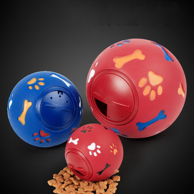 Red rubber pet toy with paw print and bone cutouts, featuring a rotating treat-dispensing mechanism. - Image 3