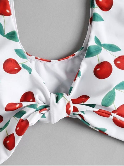 White two-piece bikini swimsuit with red cherry print, featuring a tie-front V-neck top and high-waisted bottoms. - Image 5
