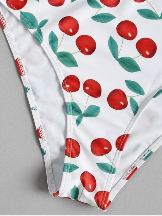 White two-piece bikini swimsuit with red cherry print, featuring a tie-front V-neck top and high-waisted bottoms. - Image 3