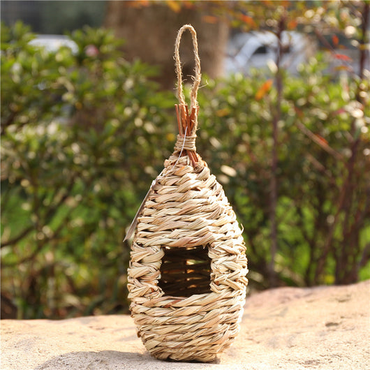 Hand-knitted straw bird's nest with a dome shape and small entrance, hanging by a twine loop. - Image 7