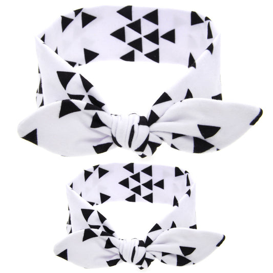 Two blue headbands with white polka dots and knotted bows, one adult-sized and one child-sized, for a matching set. - Image 2