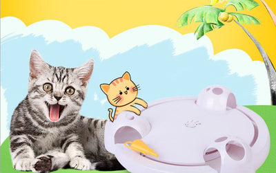 White interactive cat toy with a yellow feather, designed for mouse pouncing, next to a silver tabby cat. - Image 7