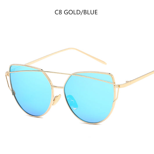 Gold metal cat-eye sunglasses with pink mirrored lenses on a white background. - Image 5