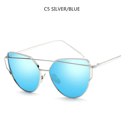 Gold metal cat-eye sunglasses with pink mirrored lenses on a white background. - Image 7