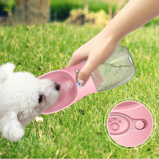 White portable pet water bottle with a clear reservoir and built-in drinking bowl, shown in a bag. - Image 7