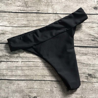 Black solid color bikini bottom with a high-cut leg and a wide, folded cross strap waistband. - Image 6